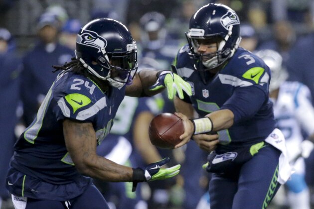 Seattle Seahawks running back Marshawn Lynch, left, takes a handoff from quarterback Russell Wilson against the Carolina Panthers during the first half of an NFL divisional playoff football game in Seattle, Saturday, Jan. 10, 2015. (AP Photo/Ted S. Warren) Seattle Seahawks running back Marshawn Lynch, left, takes a handoff from quarterback Russell Wilson against the Carolina Panthers during the first half of an NFL divisional playoff football game in Seattle, Saturday, Jan. 10, 2015. (AP Photo/Ted S. Warren)