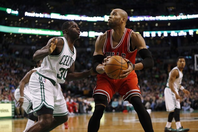 Boston Celtics' Brandon Bass (30) defends against Chicago Bulls' Taj Gibson during the fourth quarter of an NBA basketball game in Boston, Friday, Jan. 16, 2015. The Bulls won 119-103. (AP Photo/Michael Dwyer)