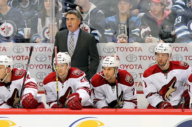 WINNIPEG, CANADA - JANUARY 18: Head Coach Dave Tippett of the Arizona Coyotes and players Joe Vitale #14, Lauri Korpikoski #28, Kyle Chipchura #24 and Sam Gagner #9 watch third period action against the Winnipeg Jets from the bench on January 18, 2015 at the MTS Centre in Winnipeg, Manitoba, Canada.  (Photo by Jonathan Kozub/NHLI via Getty Images)