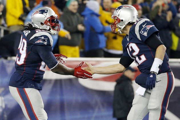 New England Patriots running back LeGarrette Blount (29) is congratulated by quarterback Tom Brady after scoring on a one-yard touchdown run during the first half of the NFL football AFC Championship game between the Patriots and Indianapolis Colts Sunday, Jan. 18, 2015, in Foxborough, Mass. (AP Photo/Elise Amendola)