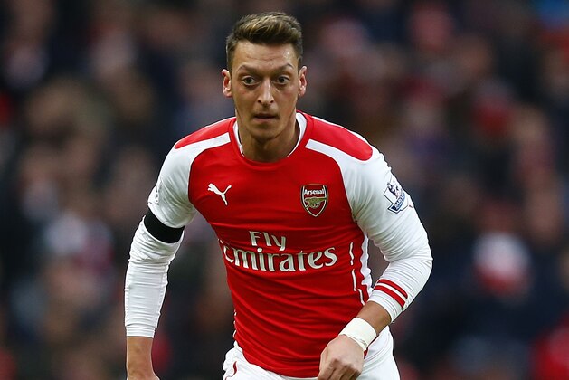 LONDON, ENGLAND - JANUARY 11:  Mesut Oezil of Arsenal runs with the ball during the Barclays Premier League match between Arsenal and Stoke City at Emirates Stadium on January 11, 2015 in London, England.  (Photo by Clive Rose/Getty Images)