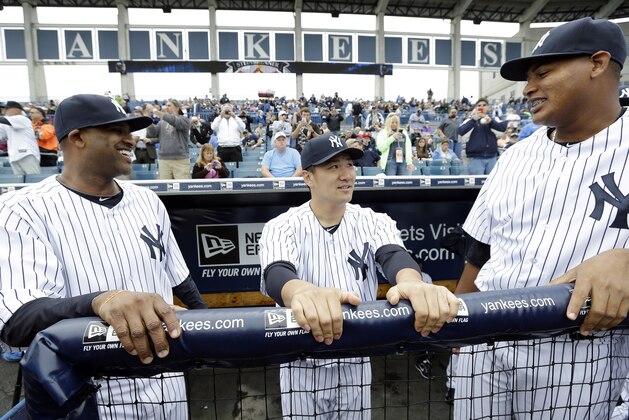New York Yankees pitcher Masahiro Tanaka, center, talks with teammates pitcher CC Sabathia, left, and pitcher Ivan Nova, right, before an exhibition baseball game against the Pittsburgh Pirates Thursday, Feb. 27, 2014, in Tampa, Fla. (AP Photo/Charlie Neibergall)