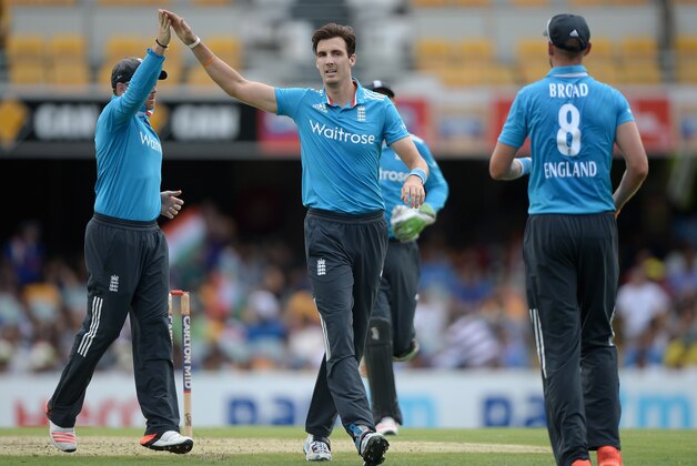 BRISBANE, AUSTRALIA - JANUARY 20:  Steven Finn of England celebrates with James Tredwell and Stuart Broad after dismissing Ajinkya Rahane of India during the One Day International match between England and India at The Gabba on January 20, 2015 in Brisbane, Australia.  (Photo by Gareth Copley/Getty Images)