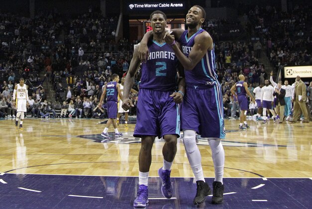 Charlotte Hornets' Michael Kidd-Gilchrist, right, hugs teammate Marvin Williams, left, after Williams made a basket against the Indiana Pacers during overtime of an NBA basketball game in Charlotte, N.C., Saturday, Jan. 17, 2015. The Hornets won 80-71 in overtime. (AP Photo/Chuck Burton)