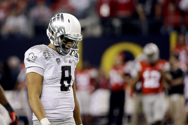 Oregon's Marcus Mariota walks off the field during the second half of the NCAA college football playoff championship game against Ohio State Monday, Jan. 12, 2015, in Arlington, Texas. (AP Photo/David J. Phillip)