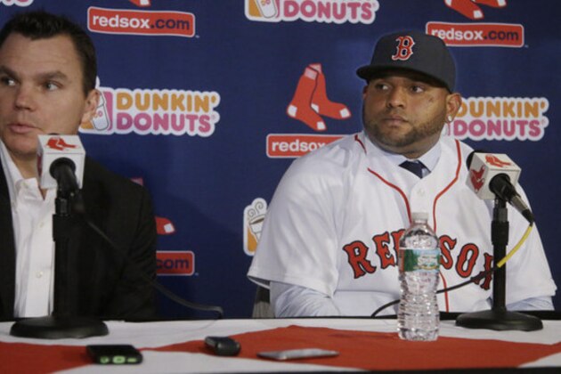 Newly acquired Boston Red Sox free agent third baseman Pablo Sandoval looks on as Red Sox general manager Ben Cherington answers a reporter's question after Sandoval is introduced to the media at Fenway Park Tuesday, Nov. 25, 2014 in Boston. (AP Photo/Stephan Savoia)