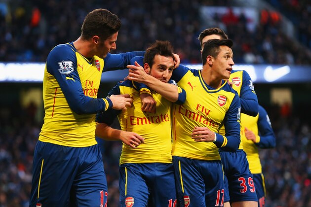 MANCHESTER, ENGLAND - JANUARY 18:  Santi Cazorla of Arsenal (2L) celebrates with team mates as he scores their first goal from a penalty during the Barclays Premier League match between Manchester City and Arsenal at Etihad Stadium on January 18, 2015 in Manchester, England.  (Photo by Alex Livesey/Getty Images)