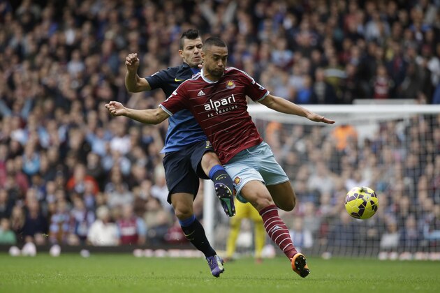 West Ham's Winston Reid, right, competes for the ball with Manchester City's Sergio Aguero during the English Premier League soccer match between West Ham and Manchester City at Upton Park stadium in London, Saturday, Oct. 25, 2014. (AP Photo/Matt Dunham)