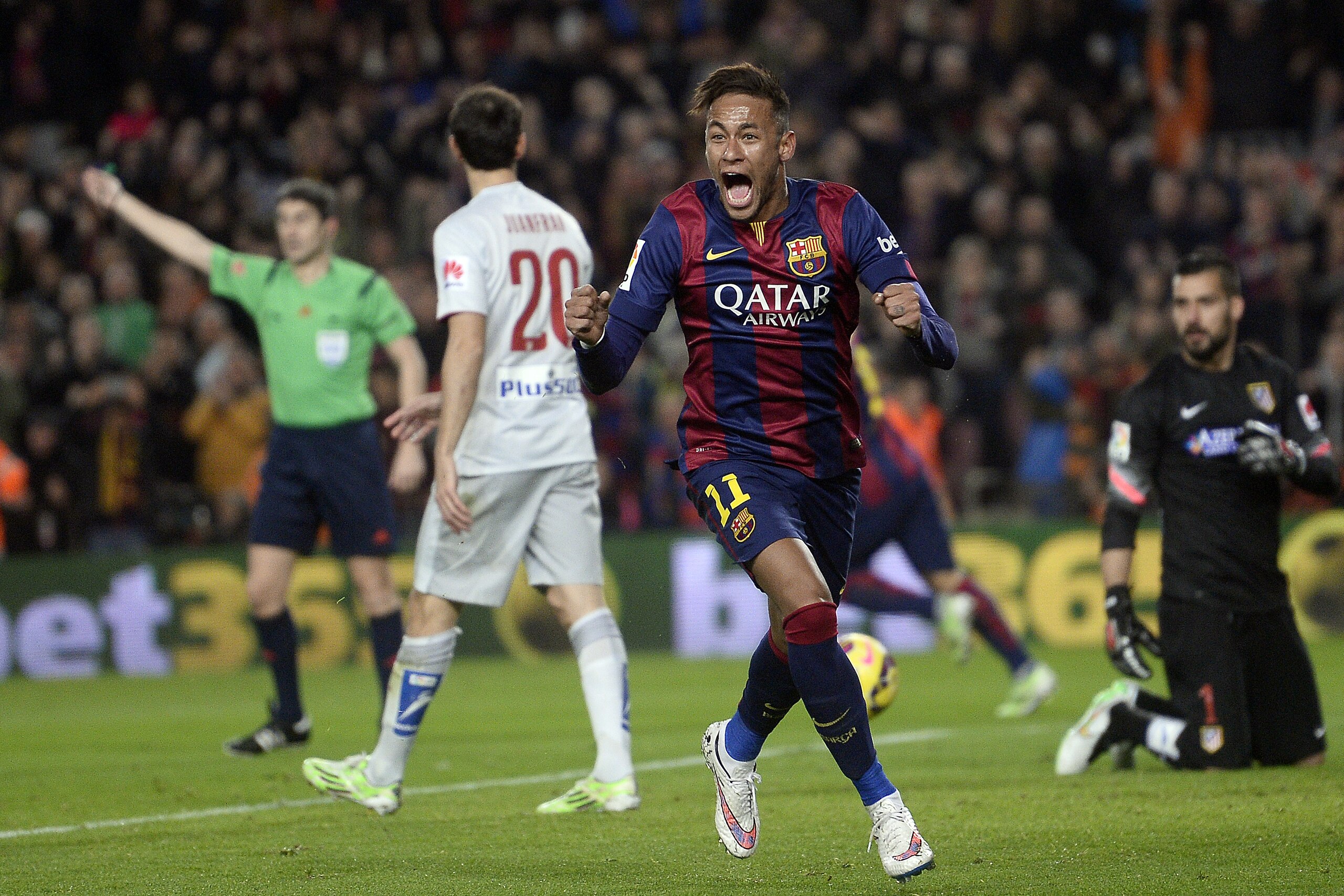 FC Barcelona's Neymar, from Brazil, centre,  reacts after scoring against Atletico Madrid during a Spanish La Liga soccer match at the Camp Nou stadium in Barcelona, Spain, Sunday, Jan. 11, 2015. (AP Photo/Manu Fernandez)