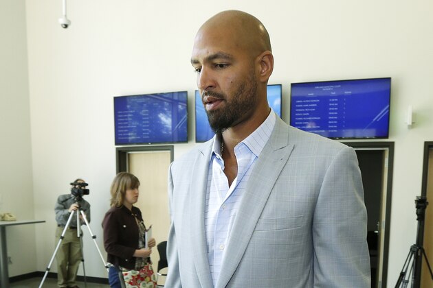 Jerramy Stevens, the husband of U.S. women's soccer goalkeeper Hope Solo, walks out of Kirkland Municipal Court Monday, June 23, 2014, in Kirkland, Wash.  Solo appeared in court in connection with her arrest for domestic violence Saturday in Kirkland, where she was accused of assaulting her sister and 17-year-old nephew. (AP Photo/Ted S. Warren)