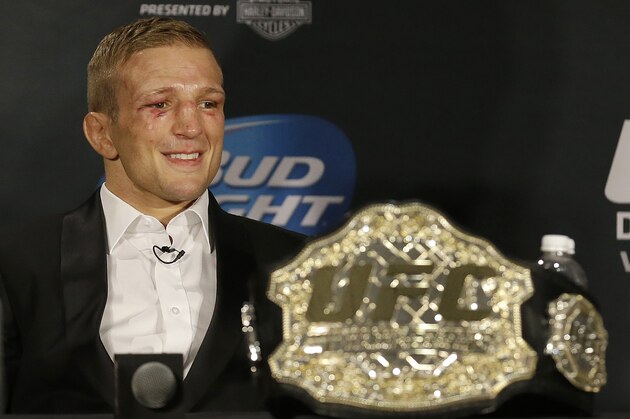 T.J. Dillashaw smiles at a news conference after defeating Joe Soto in a bantamweight championship mixed martial arts bout at UFC 177 in Sacramento, Calif., Saturday, Aug. 30, 2014. Dillashaw won by technical knockout in the fifth round to retain his championship. (AP Photo/Jeff Chiu)