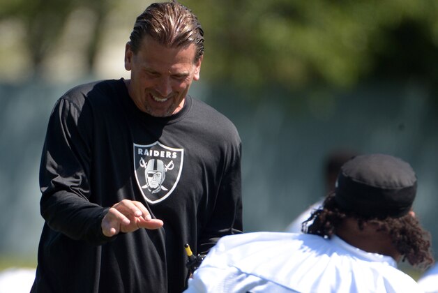 May 27, 2014; Alameda, CA, USA; Oakland Raiders offensive coordinator Greg Olson talks with tackle Donald Penn (72) at organized team activities at the Raiders practice facility. Mandatory Credit: Kirby Lee-USA TODAY Sports