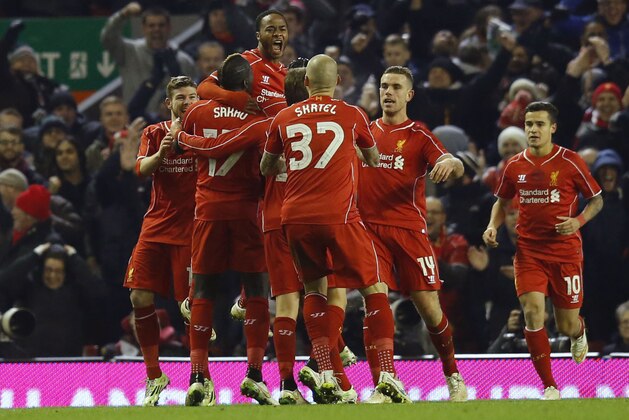 Liverpool's Raheem Sterling, top, celebrates his goal with teammates during the English League Cup semi-final first leg soccer match between Liverpool and Chelsea at Anfield Stadium, Liverpool, England, Tuesday Jan. 20, 2015. (AP Photo/Jon Super)