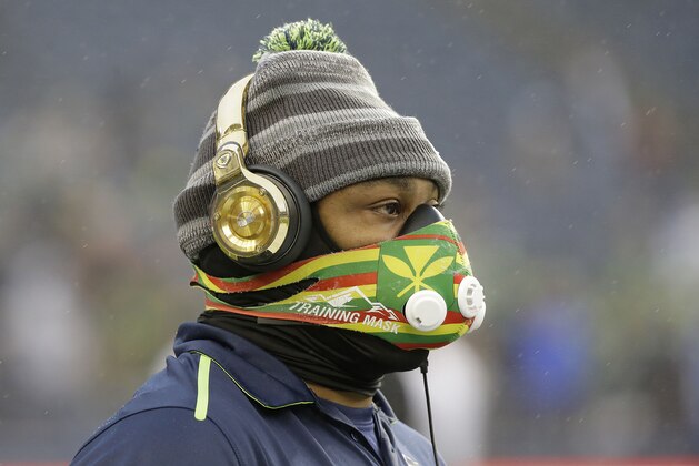 Seattle Seahawks running back Marshawn Lynch walks on the field before an NFL divisional playoff football game against the Carolina Panthers in Seattle, Saturday, Jan. 10, 2015. (AP Photo/Ted S. Warren)