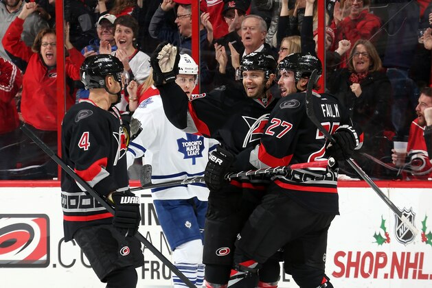 RALEIGH, NC - DECEMBER 18:  Andrej Sekera #4, Patrick Dwyer #39 and Justin Faulk #27 of the Carolina Hurricanes celebrate following Faulk's shorthanded goal in the first period as Jake Gardiner #51 of the Toronto Maple Leafs looks on during an NHL game at PNC Arena on December 18, 2014 in Raleigh, North Carolina.  (Photo by Gregg Forwerck/NHLI via Getty Images)