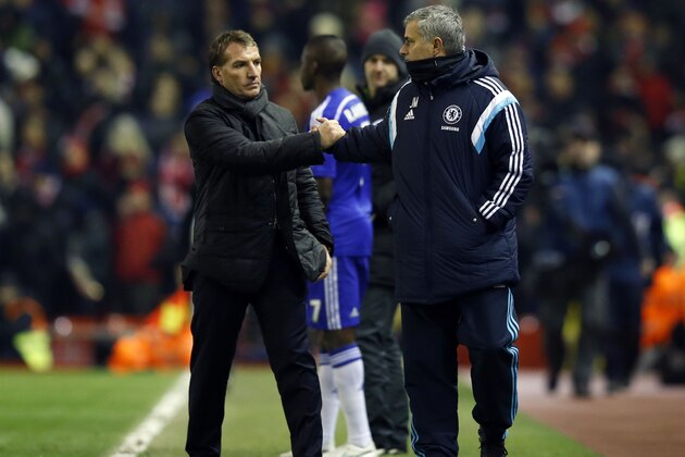 Liverpool's head coach Brendan Rodgers, left, shakes hands with Chelsea's head coach Jose Mourinho at the end of the English League Cup semi-final first leg soccer match between Liverpool and Chelsea at Anfield Stadium, Liverpool, England, Tuesday Jan. 20, 2015. (AP Photo/Jon Super)