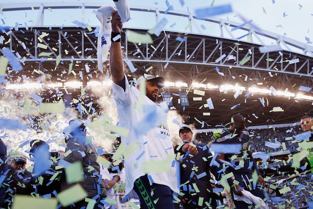 SEATTLE, WA - JANUARY 18:  Quarterback Russell Wilson #3 of the Seattle Seahawks celebrate after the Seahawks 28-22 victory in overtime against the Green Bay Packers during the 2015 NFC Championship game at CenturyLink Field on January 18, 2015 in Seattle, Washington.  (Photo by Tom Pennington/Getty Images)