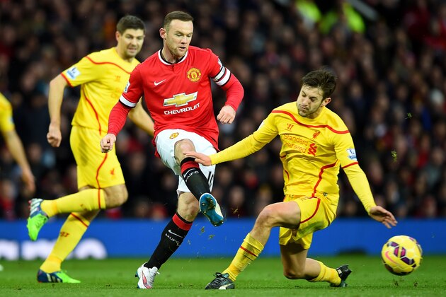 MANCHESTER, ENGLAND - DECEMBER 14:  Wayne Rooney of Manchester United competes with Adam Lallana of Liverpool during the Barclays Premier League match between Manchester United and Liverpool at Old Trafford on December 14, 2014 in Manchester, England.  (Photo by Shaun Botterill/Getty Images)