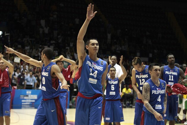Japeth Aguilar of the Philippines, center, waves with teammates after winning the Group B Basketball World Cup match against Senegal in Seville, Spain, Thursday, Sept. 4, 2014. The 2014 Basketball World Cup competition will take place in various cities in Spain from Aug. 30 through to Sept. 14. (AP Photo/Miguel Angel Morenatti)