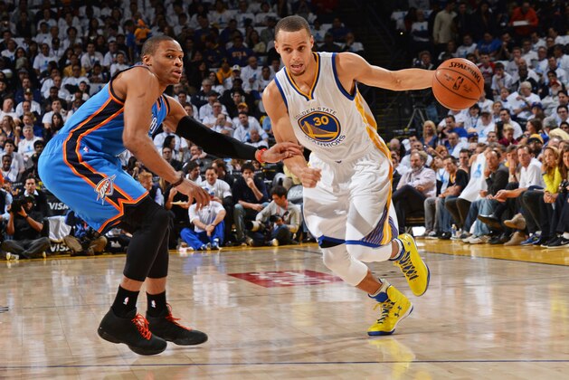 OAKLAND, CA - JANUARY 5:  Stephen Curry #30 of the Golden State Warriors handles the ball against Russell Westbrook #0 of the Oklahoma City Thunder during the game on January 5, 2015 at Oracle Arena in Oakland, California. NOTE TO USER: User expressly acknowledges and agrees that, by downloading and or using this photograph, user is consenting to the terms and conditions of Getty Images License Agreement. Mandatory Copyright Notice: Copyright 2015 NBAE (Photo by Noah Graham/NBAE via Getty Images)
