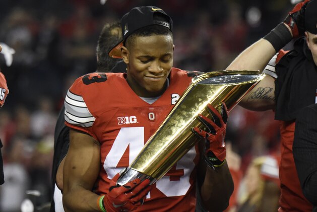 Jan 12, 2015; Arlington, TX, USA; Ohio State Buckeyes linebacker Darron Lee (43) holds the trophy after their win over the Oregon Ducks in the 2015 CFP National Championship Game at AT&T Stadium. Ohio State won 42-20.  Mandatory Credit: Kirby Lee-USA TODAY Sports