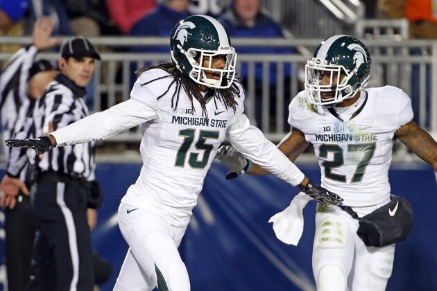 Michigan State cornerback Trae Waynes (15) celebrates with Kurtis Drummond (27) after intercepting a pass intended for Penn State wide receiver Chris Godwin (12) in the end zone for a touchback during the second half of an NCAA college football game in State College, Pa., Saturday, Nov. 29, 2014. (AP Photo/Gene J. Puskar)