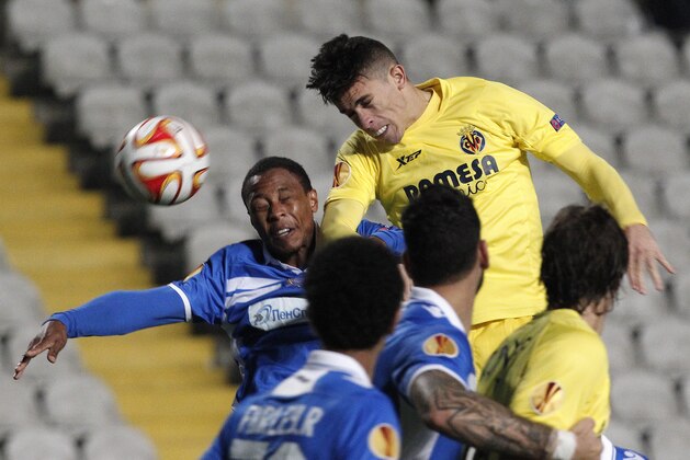 Apollon's Dustley Mulder, left, jumps for the ball with Villarreal's Gabriel Paulista during the Europa League Group A soccer match between Apollon and Villarreal, Spain, at GSP stadium in Nicosia, Cyprus, Thursday, Dec. 11, 2014. (AP Photo/Petros Karadjias)
