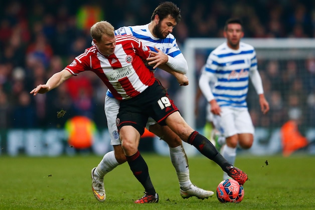 LONDON, ENGLAND - JANUARY 04:  Charlie Austin of QPR tangles with James McEveley of Sheffield United during the FA Cup Third Round match between Queens Park Rangers and Sheffield United at Loftus Road on January 4, 2015 in London, England.  (Photo by Julian Finney/Getty Images)