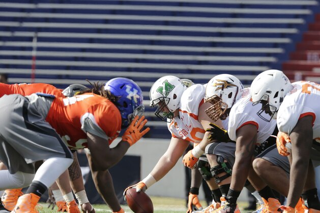 Senior Bowl players line to run through a drill during NCAA college football practice for the Senior Bowl, Tuesday, Jan. 20, 2015, at Ladd-Peebles Stadium in Mobile, Ala. (AP Photo/Brynn Anderson)