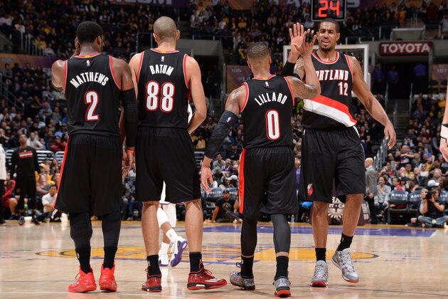 LOS ANGELES, CA - JANUARY 11:  LaMarcus Aldridge #12, Damian Lillard #0 of the Portland Trail Blazers and their teammates celebrate during the game against the Los Angeles Lakers on January 11, 2015 at STAPLES Center in Los Angeles, California. NOTE TO USER: User expressly acknowledges and agrees that, by downloading and/or using this Photograph, user is consenting to the terms and conditions of the Getty Images License Agreement. Mandatory Copyright Notice: Copyright 2015 NBAE (Photo by Andrew D. Bernstein/NBAE via Getty Images)