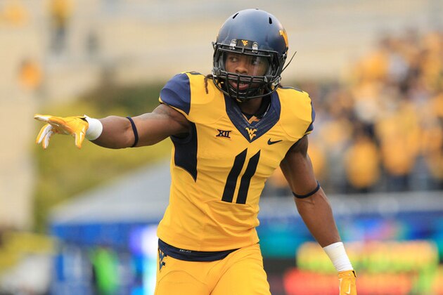 West Virginia's Kevin White (11) checks is lineup during their NCAA college football game against Kansas in Morgantown, W.Va., Saturday, Oct. 4, 2014. West Virginia won 33-14. (AP Photo/Chris Jackson)