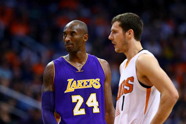 Oct 29, 2014; Phoenix, AZ, USA; Los Angeles Lakers guard Kobe Bryant (24) stands alongside Phoenix Suns guard Goran Dragic (1) during the home opener at US Airways Center. The Suns defeated the Lakers 119-99. Mandatory Credit: Mark J. Rebilas-USA TODAY Sports
