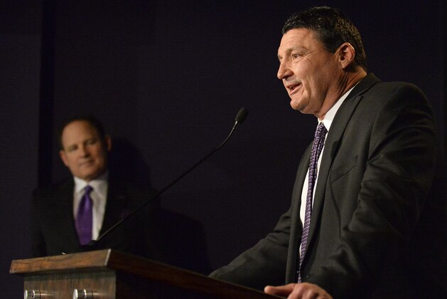 With head coach Les Miles, left, looking on, newly appointed LSU defensive line coach Ed Orgeron speaks during a news conference at Louisiana State in Baton Rouge, La., Wednesday, Jan. 14, 2015. (AP Photo/Hilary Scheinuk)