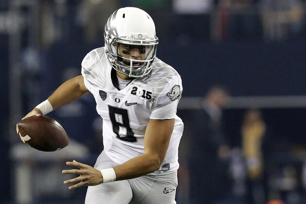 FILE - In this Monday Jan. 12, 2015, file photo, Oregon's Marcus Mariota (8) runs against Ohio State during the first half of the NCAA college football playoff championship game in Arlington, Texas. Mariota, the Heisman Trophy winner, has declared his eligibility for the NFL draft, in an announcement on Oregon's website, Wednesday, Jan. 14, 2015. (AP Photo/LM Otero, File)