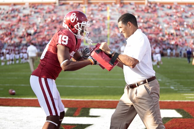 NORMAN, OK - SEPTEMBER 22:  Co-offensive coordinator Jay Norvell and wide receiver Justin Brown #19 of the Oklahoma Sooners warm up before the game against the Kansas State Wildcats  on September 22, 2012 at Gaylord Family-Oklahoma Memorial Stadium in Norman, Oklahoma. Kansas State beat Oklahoma 24-19. (Photo by Brett Deering/Getty Images)