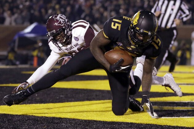 Missouri wide receiver Dorial Green-Beckham, front, falls in the end zone after catching a 38-yard touchdown pass as Texas A&M defensive back Deshazor Everett defends during the second quarter of an NCAA college football game on Saturday, Nov. 30, 2013, in Columbia, Mo. (AP Photo/Jeff Roberson)