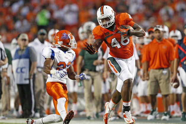 MIAMI GARDENS, FL - SEPTEMBER 21: Clive Walford #46 of the Miami Hurricanes runs with the ball while being defended by Romahn Hemingway #23 of the Savannah State Tigers on September 21, 2013 at Sun Life Stadium in Miami Gardens, Florida. Miami defeated Savannah State 77-7. (Photo by Joel Auerbach/Getty Images)