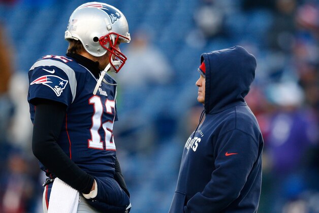 FOXBORO, MA - JANUARY 10:  Tom Brady #12 and head coach Bill Belichick of the New England Patriots talk before the 2014 AFC Divisional Playoffs game against the Baltimore Ravens at Gillette Stadium on January 10, 2015 in Foxboro, Massachusetts.  (Photo by Jim Rogash/Getty Images)