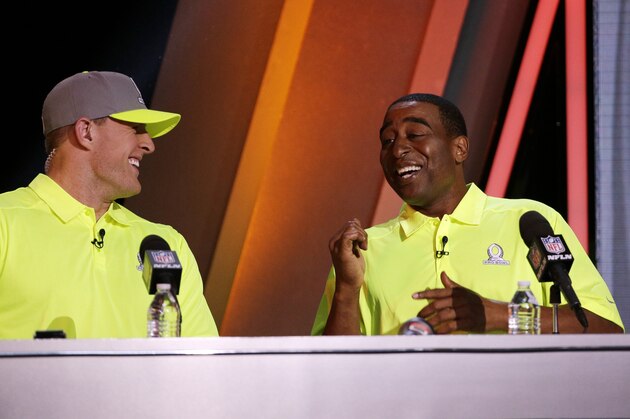 Cris Carter, right,  talks to Houston Texan's J.J. Watt during the Pro Bowl draft Wednesday, Jan. 21, 2015, in Phoenix. (AP Photo/David J. Phillip)