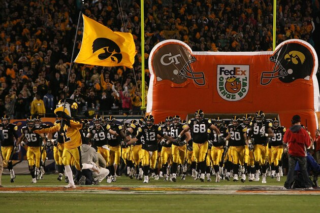 MIAMI GARDENS, FL - JANUARY 05:  Herky, the Iowa mascot, runs out with a flag as quarterback Ricky Stanzi #12 of the Iowa Hawkeyes leads his team onto the field against the Georgia Tech Yellow Jackets during the FedEx Orange Bowl at Land Shark Stadium on January 5, 2010 in Miami Gardens, Florida.  (Photo by Doug Benc/Getty Images)