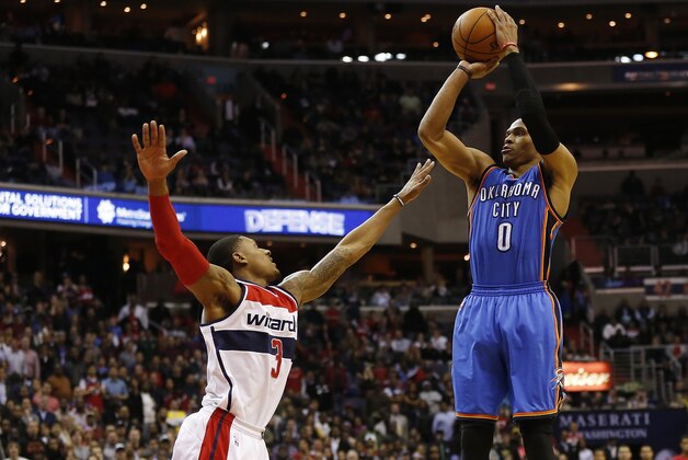 Jan 21, 2015; Washington, DC, USA; Oklahoma City Thunder guard Russell Westbrook (0) shoots the ball over Washington Wizards guard Bradley Beal (3) in the fourth quarter at Verizon Center. The Thunder won 105-103 in overtime. Mandatory Credit: Geoff Burke-USA TODAY Sports