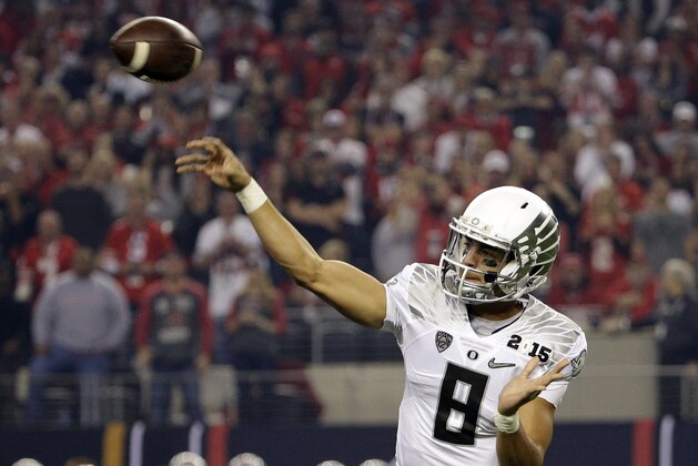 Oregon's Marcus Mariota throws during the first half of the NCAA college football playoff championship game against Ohio State Monday, Jan. 12, 2015, in Arlington, Texas. (AP Photo/David J. Phillip)