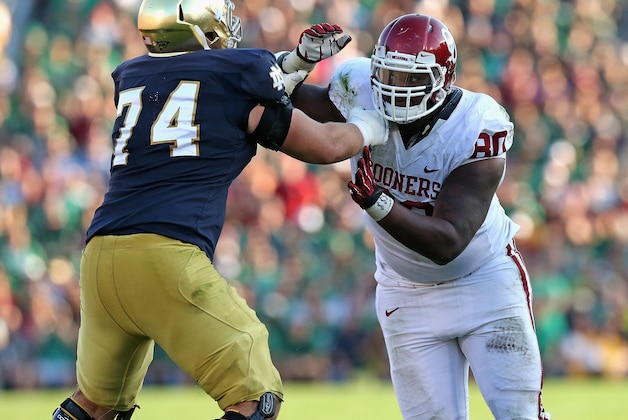 SOUTH BEND, IN - SEPTEMBER 28:  Jordan Phillips #80 of the Oklahoma Sooners rushes against Christian Lombard #74 of the Notre Dame Fighting Irish at Notre Dame Stadium on September 28, 2013 in South Bend, Indiana. Oklahoma defeated Notre Dame 35-21.  (Photo by Jonathan Daniel/Getty Images)