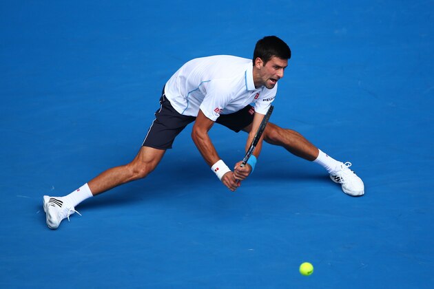 MELBOURNE, AUSTRALIA - JANUARY 22:  Novak Djokovic of Serbia plays a backhand in his second round match against Andrey Kuznetsov of Russia during day four of the 2015 Australian Open at Melbourne Park on January 22, 2015 in Melbourne, Australia.  (Photo by Clive Brunskill/Getty Images)