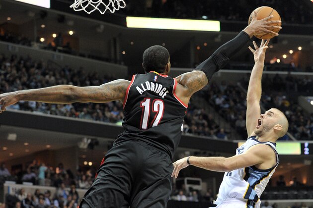 Portland Trail Blazers forward LaMarcus Aldridge (12) blocks a shot by Memphis Grizzlies guard Nick Calathes during the second half of an NBA basketball game Saturday, Jan. 17, 2015, in Memphis, Tenn. The Grizzlies won 102-98. (AP Photo/Brandon Dill)