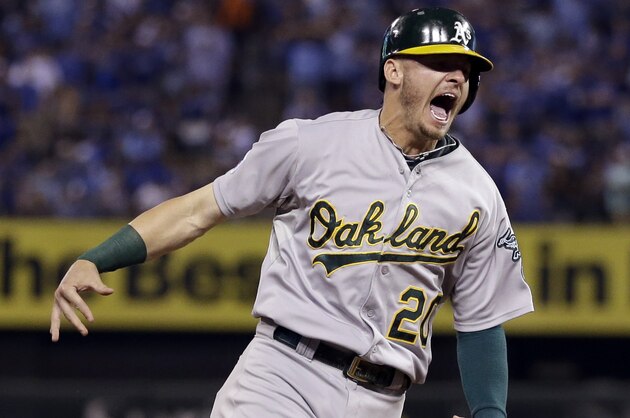 Oakland Athletics' Josh Donaldson celebrates as he rounds the bases on a three-run home run by teammate Brandon Moss during the sixth inning of the AL wild-card playoff baseball game against the Kansas City Royals Tuesday, Sept. 30, 2014, in Kansas City, Mo. The home run was Moss' second of the game. (AP Photo/Jeff Roberson)
