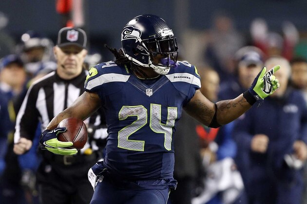 January 10, 2015; Seattle, WA, USA; Seattle Seahawks running back Marshawn Lynch (24) runs the ball against the Carolina Panthers during the second half in the 2014 NFC Divisional playoff football game at CenturyLink Field. Mandatory Credit: Joe Nicholson-USA TODAY Sports