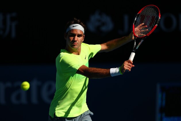 MELBOURNE, AUSTRALIA - JANUARY 21:  Roger Federer of Switzerland plays a backhand in his second round match against Simone Bolelli of Italy during day three of the 2015 Australian Open at Melbourne Park on January 21, 2015 in Melbourne, Australia.  (Photo by Clive Brunskill/Getty Images)