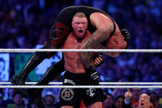 The Undertake, top, and Brock Lesnar, bottom, compete during Wrestlemania XXX at the Mercedes-Benz Super Dome in New Orleans on Sunday, April 6, 2014. (Jonathan Bachman/AP Images for WWE)