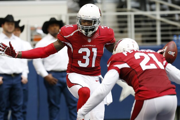 After interception the ball against the Dallas Cowboys, Arizona Cardinals cornerback Antonio Cromartie (31) celebrates with cornerback Patrick Peterson (21) during the second half of an NFL football game Sunday, Nov. 2, 2014, in Arlington, Texas. (AP Photo/Sue Ogrocki)